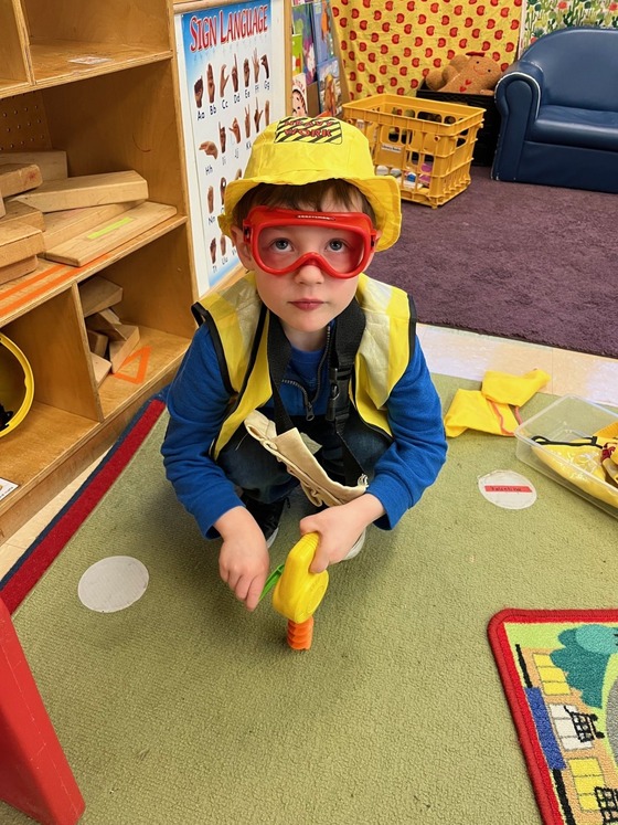 Preschooler pretending to be a construction worker