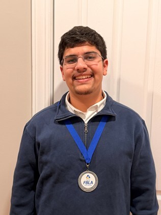 student with competition medal