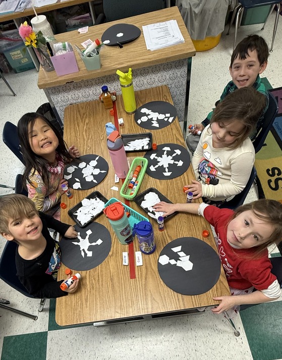 Students learning about shapes by making snowflakes