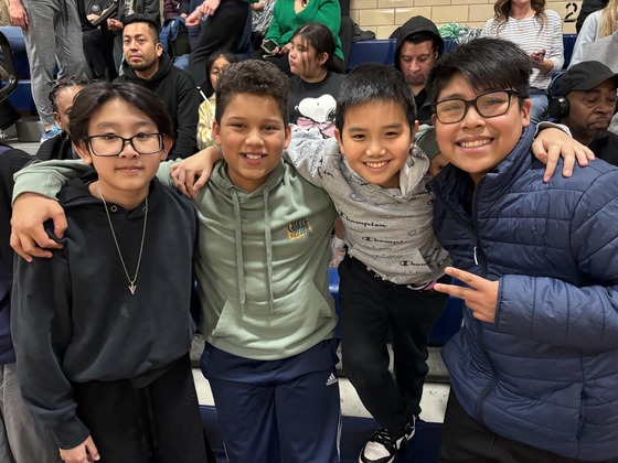 Students smile at the basketball game 