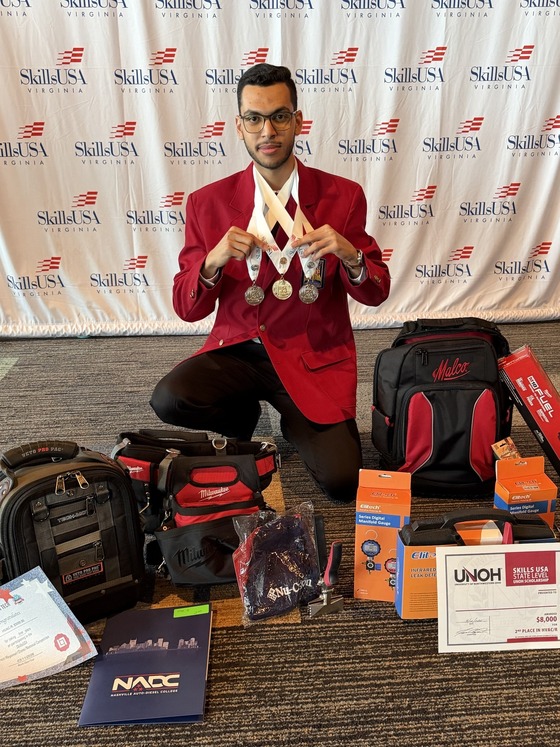 student with various prizes from a competition