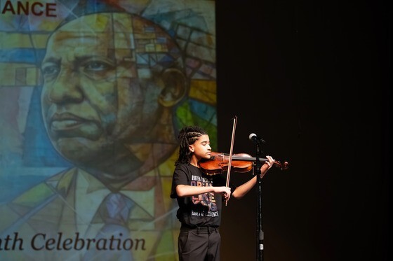 Student standing playing violin