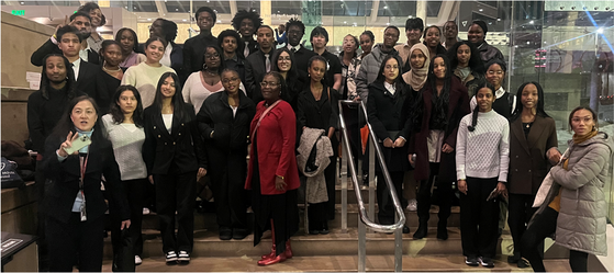 Students and staff standing together on steps