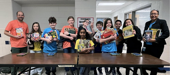 students smile with books