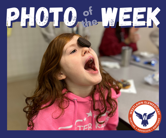 Photo of the Week: a student with an Oreo on her face and her mouth open