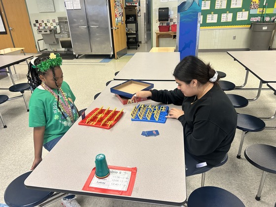Two students play games together in the cafeteria 
