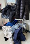 coats, sweaters, and other items in the Lost & Found pile