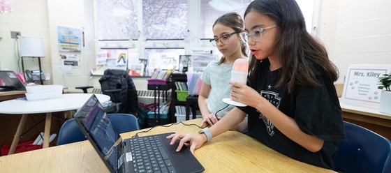 students working together on a laptop