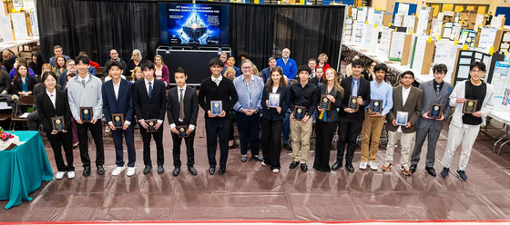 awardees smiling with their award