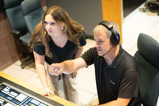 Student intern working with IT staff 