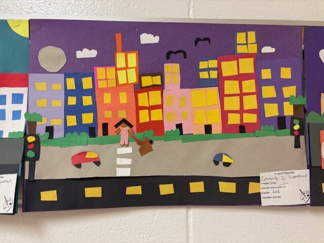 A picture of a community created by a second grade student. It features colorful buildilngs.