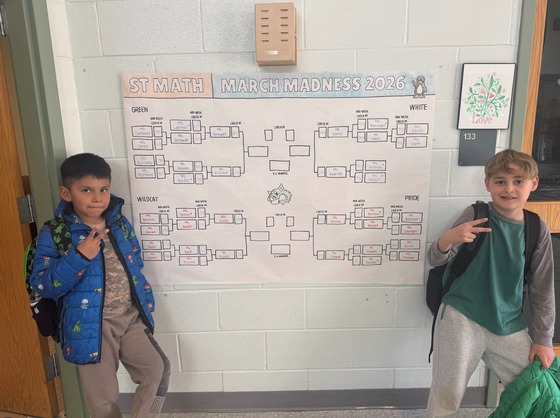 Two students stand in front of ST Math Bracket 