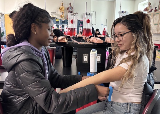 two students practicing medical procedures
