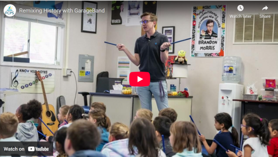 Chesterbrook Music Teacher leading a class with YouTube video arrow