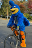Photo of Roadrunner Mascot riding a bike