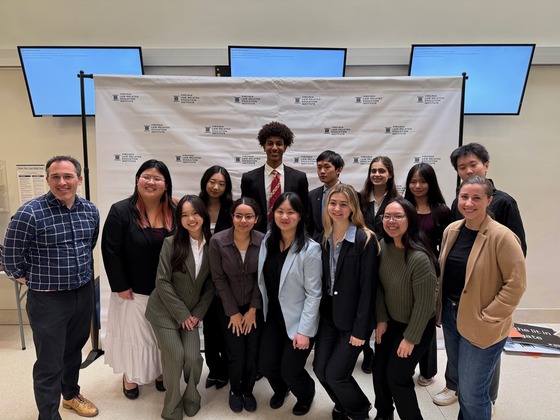 14 students smile in a group photo in front of a Virginia Law-Related Education Institute backdrop