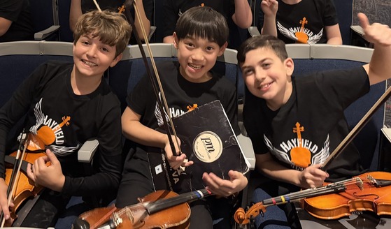 Student violinists in the Hayfield auditorium
