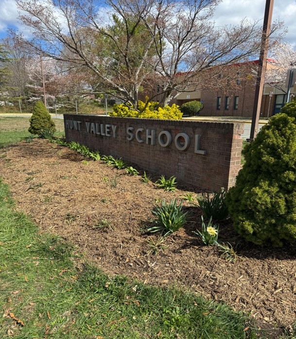 garden and sign in front of school