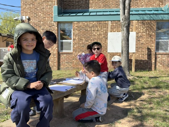 Students outside drawing pictures