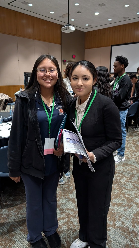 Two students smiling