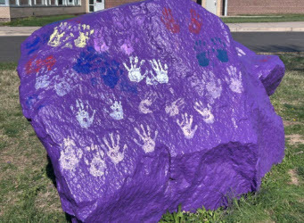 purple rock with handprints