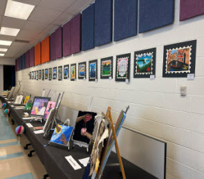 art hung on walls being displayed in art show