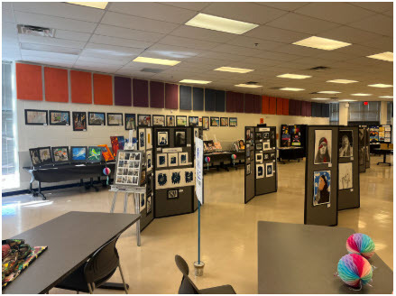 art hung on walls being displayed in art show