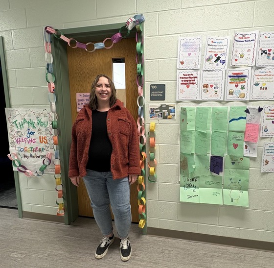 Ms. Dauberman in front of her door with cards 