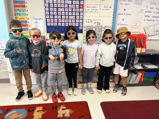 A group of students smile with sunglasses 