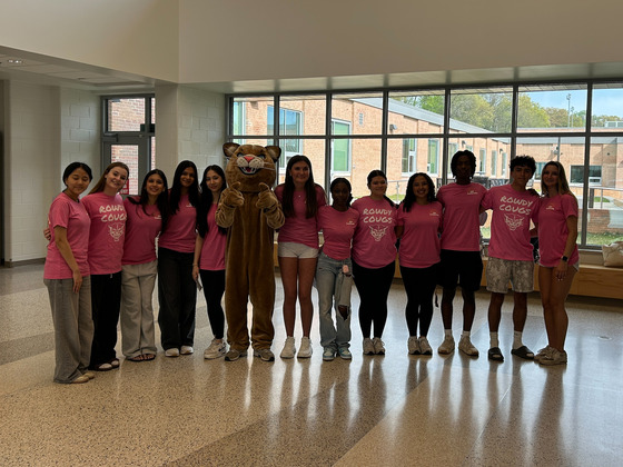 image of leadership students in pink shirts around the Cougar mascot