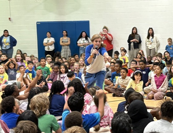 Mrs. Schadle raising spirit at the pep rally