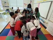 A group of students huddled around a prize box.