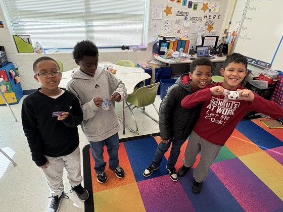 Students holding up their attendance prizes. 