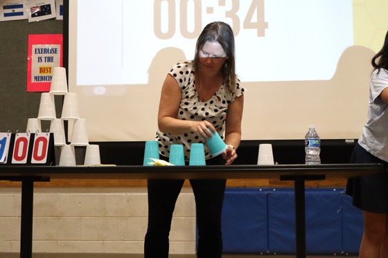 Picture of Principal Riley playing the Cup Stacking Game