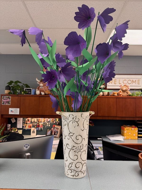 purple paper flowers in a grey vase