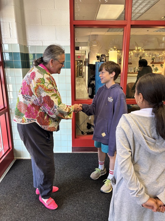 5th grader greeting Dr. Reid