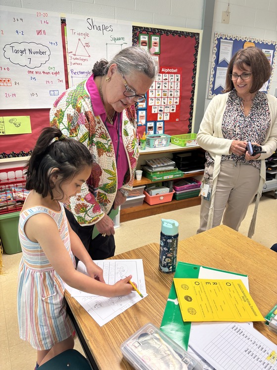 First grader reading her story to Dr. Reid