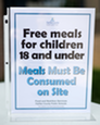 Sign from Fairfax County Public Schools that reads, “Free meals for children 18 and under. Meals must be consumed on site.”