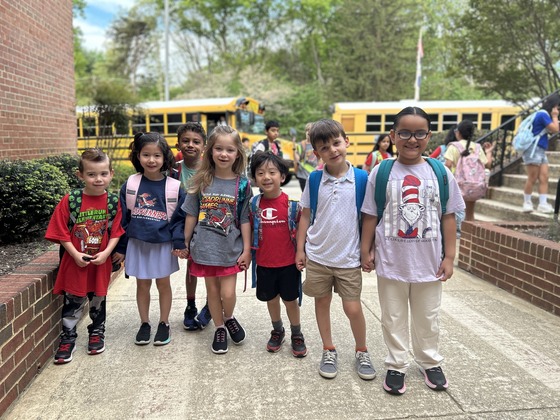 Kindergarteners smiling outside at arrival