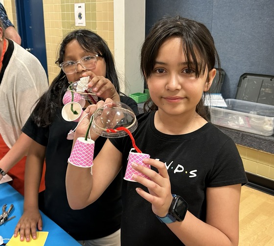 two female students holding their science creation at science night