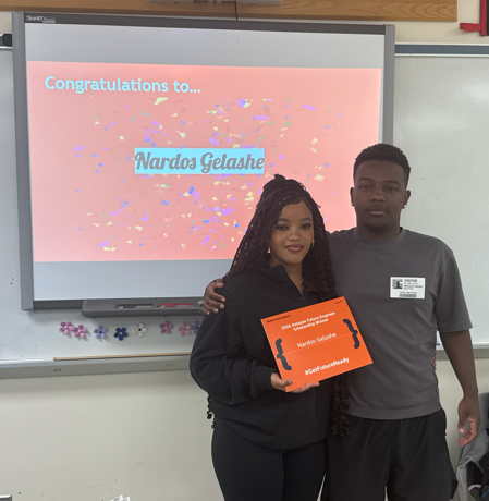 Student posing with an award