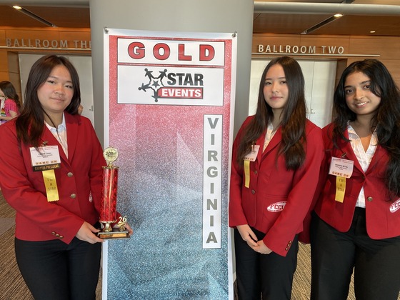 Students posing with an award