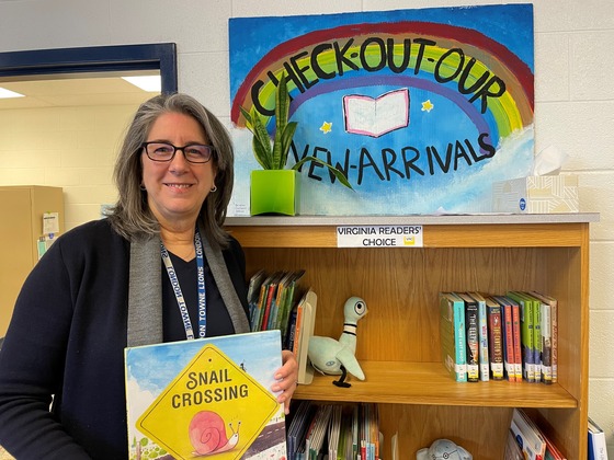 school librarian holding a book