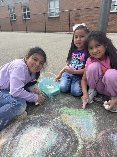 Students do chalk outside for recess 