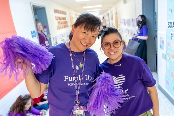 two teachers smile for a photo