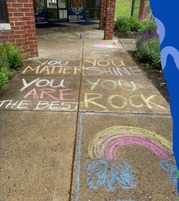 sidewalk decorated with chalk writing