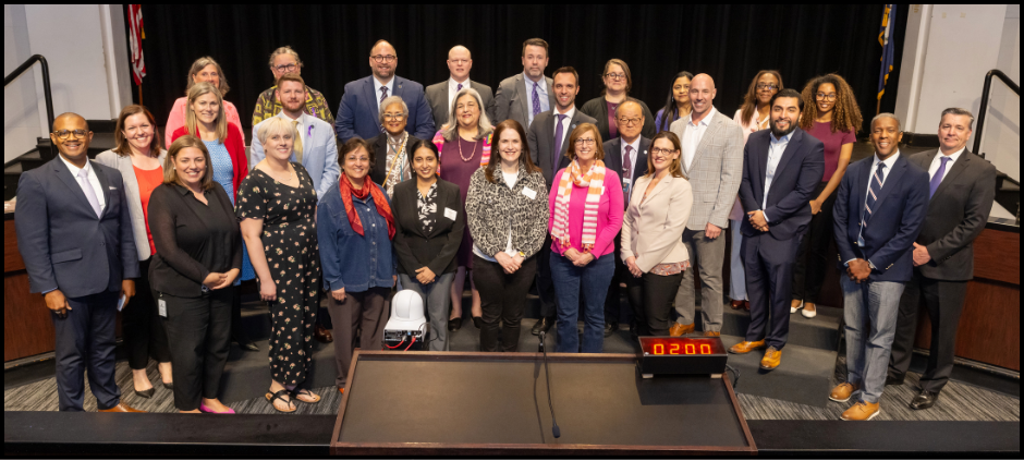 National Board Certified Teachers at the dais with school board members