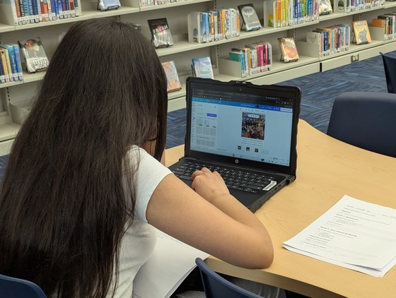 Spanish 2 students working in the library