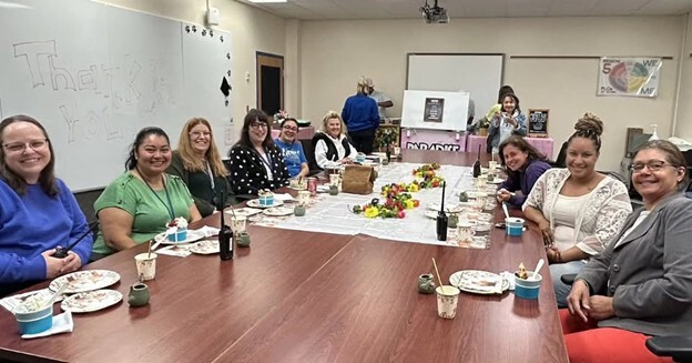 Office Staff sitting around a table having lunch