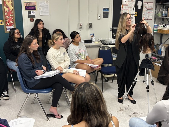 Cosmetology students learn from a guest artist